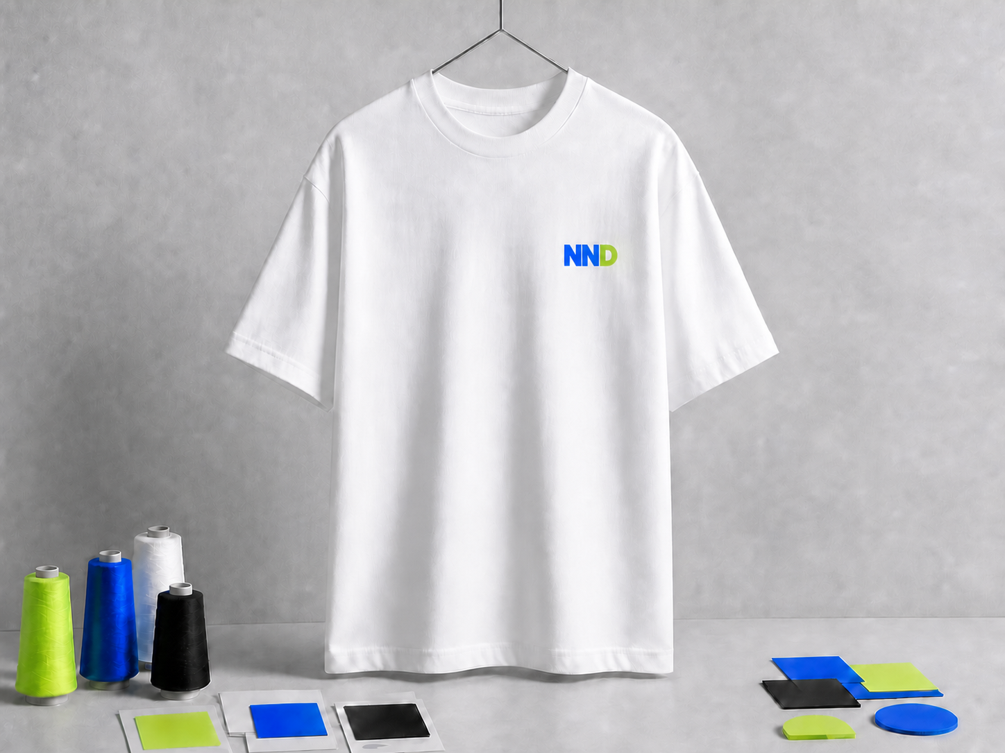 White T-shirt with a small NND chest mark, two cobalt Ns and one acid-lime D